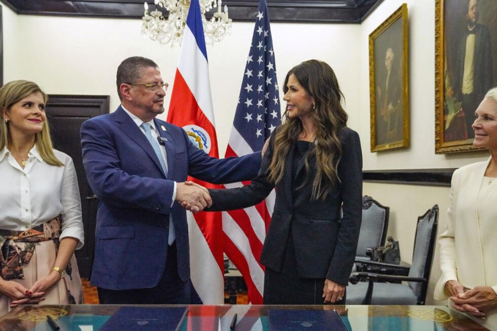 El presidente de Costa Rica, Rodrigo Chaves (i), saluda a la enviada especial del Escudo de las Américas, Kristi Noem, durante la firma de un acuerdo de cooperación migratoria con Estados Unidos este lunes, en San José (Costa Rica).