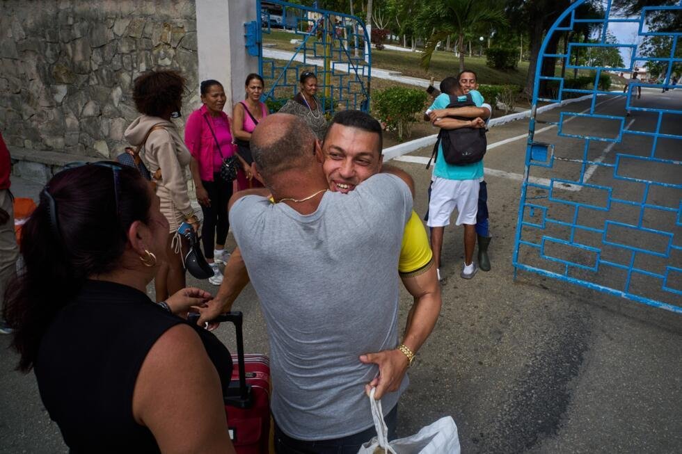Pardoned prisoners hug their families after leaving the La Lima penitentiary in Guanabo, Cuba, Friday, April 3, 2026.